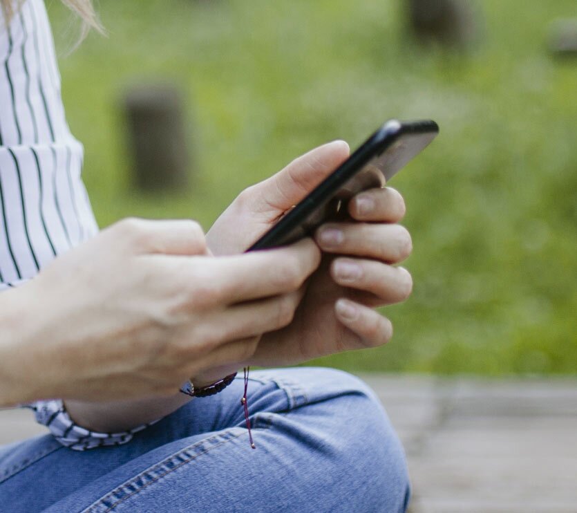 Woman reading reviews on her mobile phone